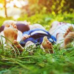 family laying on the park