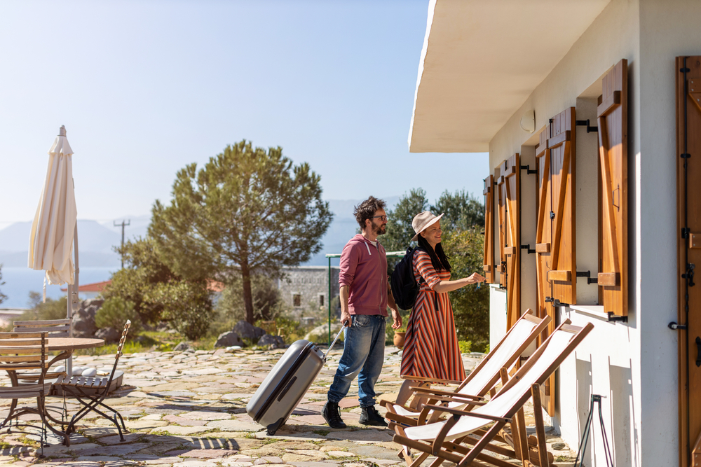 two people entering a summer home